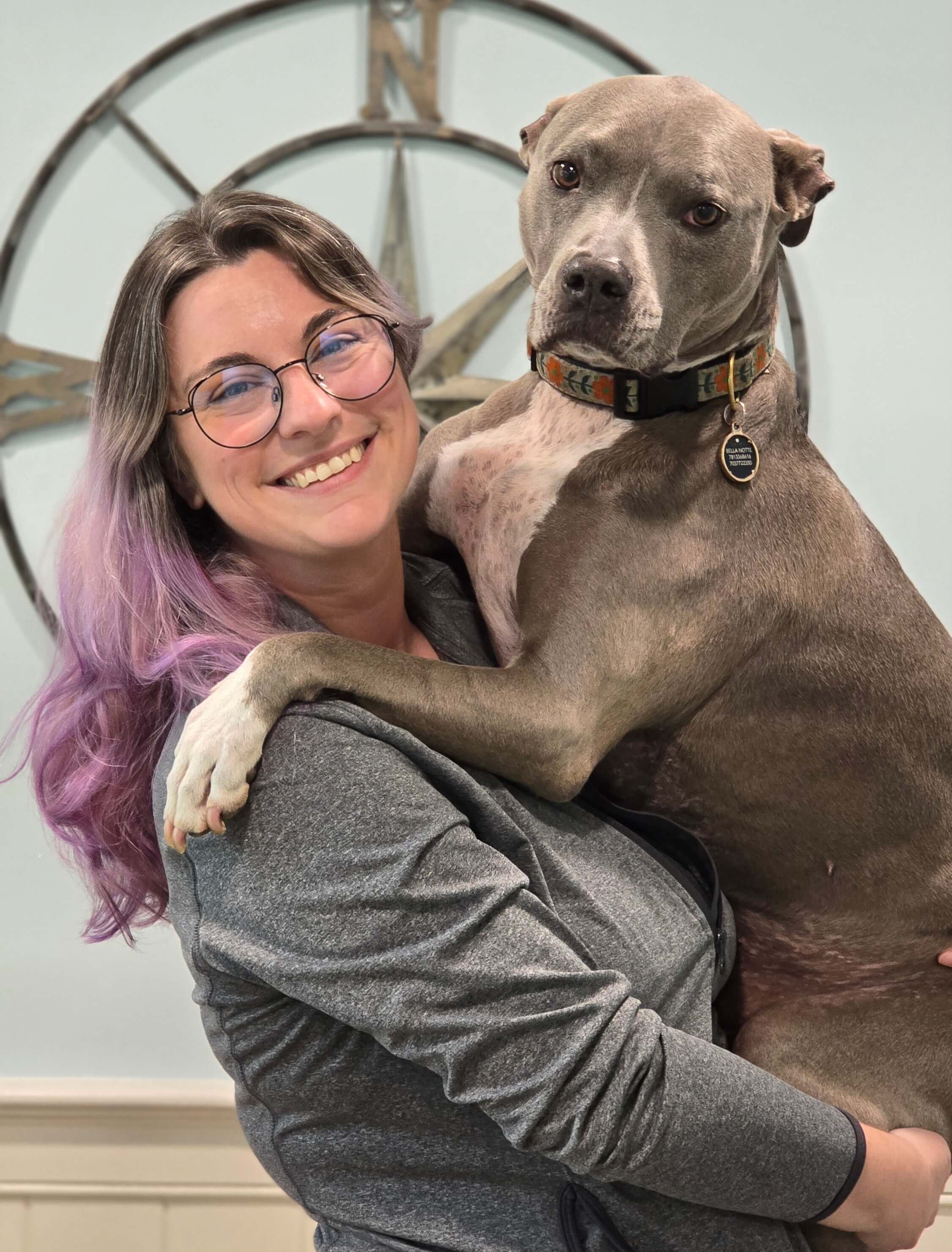 Receptionist holding dog